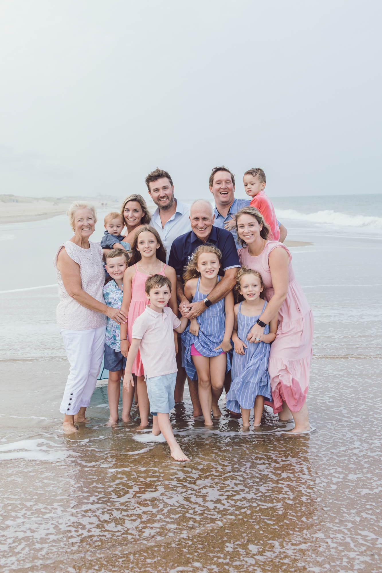 Family laughing together during beach portrait session